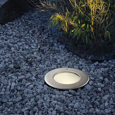 Recessed outdoor ground light on a stone pathway